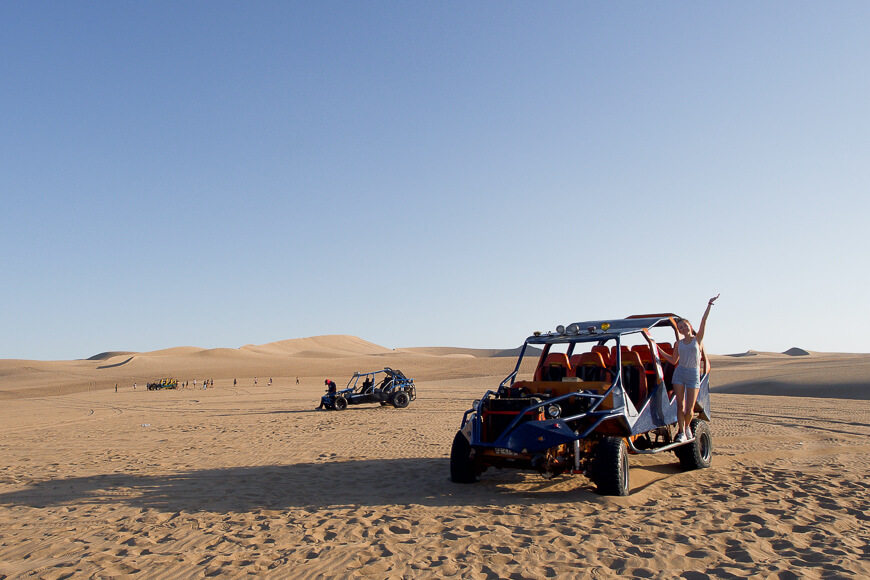 Female traveler posing on a Dune Buggy Tour in Huacachina, Peru